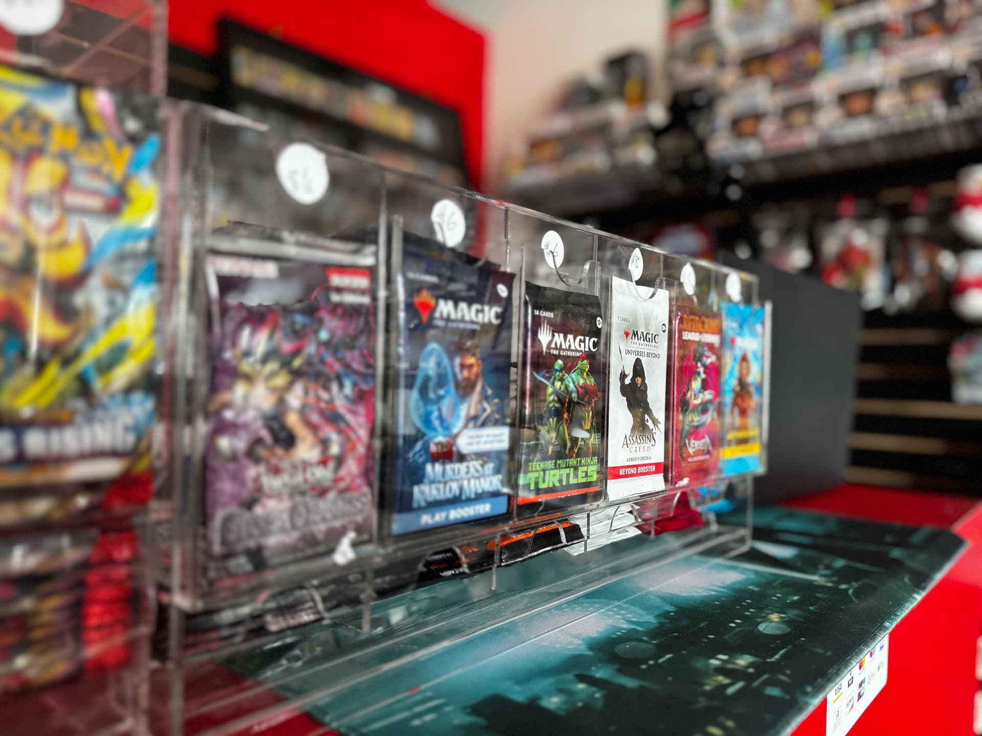 Magic: The Gathering and Pokemon booster packs on the CGX counter display